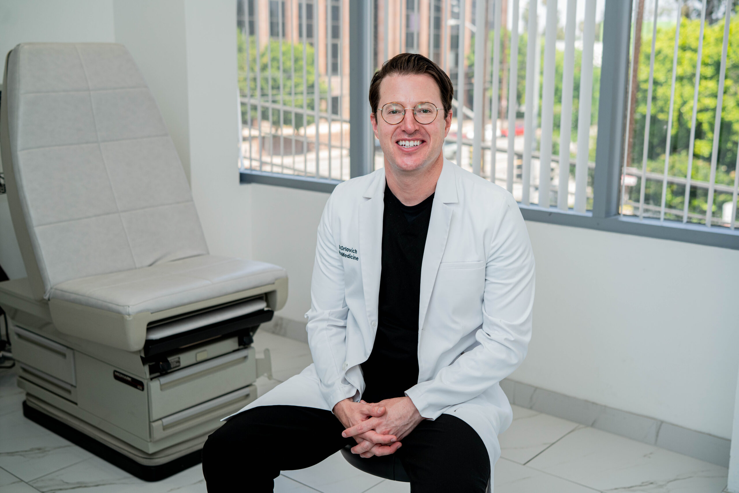 Dr. Daniel Orlovich, MD, PharmD, QME in white coat at Orlovich Pain MD clinic in Los Angeles and Sacramento